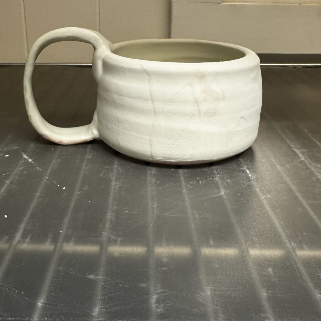 Mug with glaze applied before final firing.