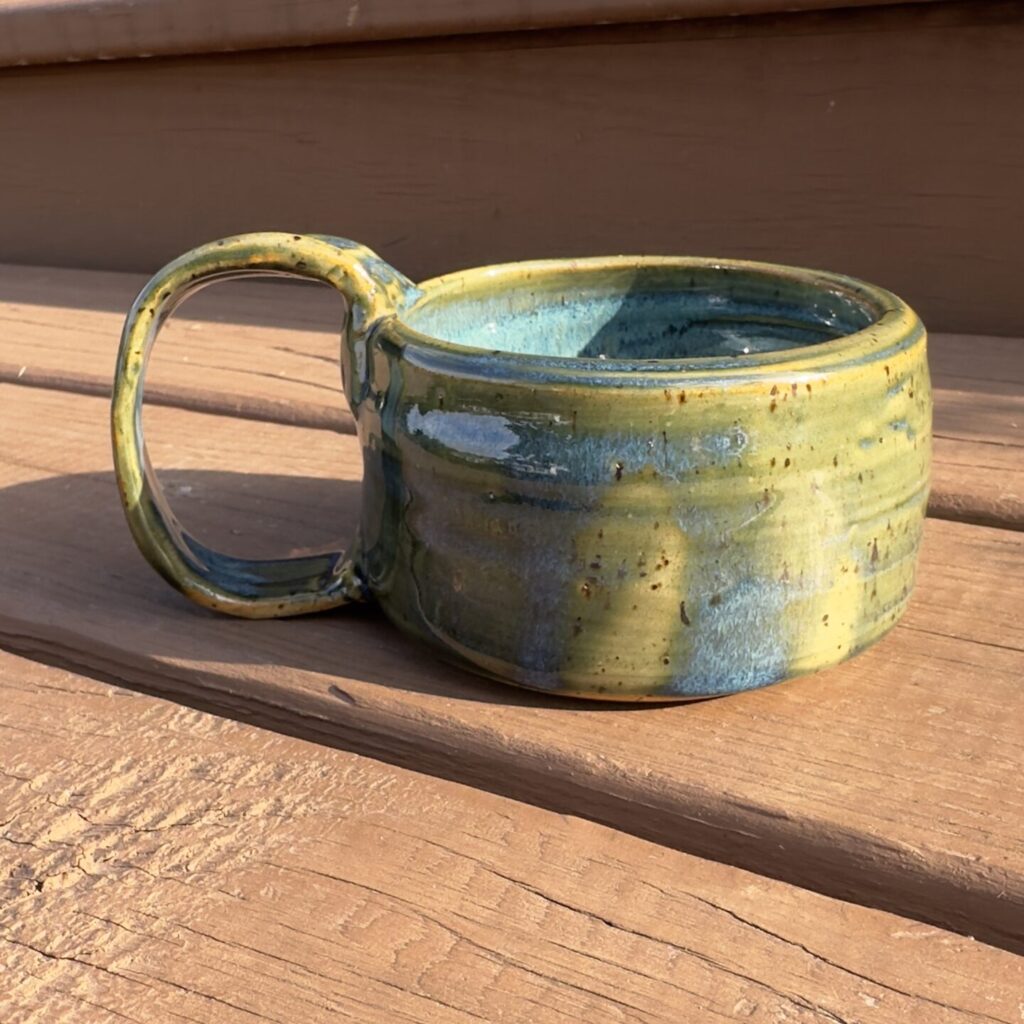 Finished mug with green and blue glaze.